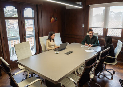 Interior de la sala de reuniones con tres personas trabajando.